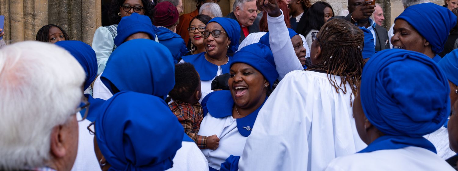 A group of women cheer at a lay ministry service